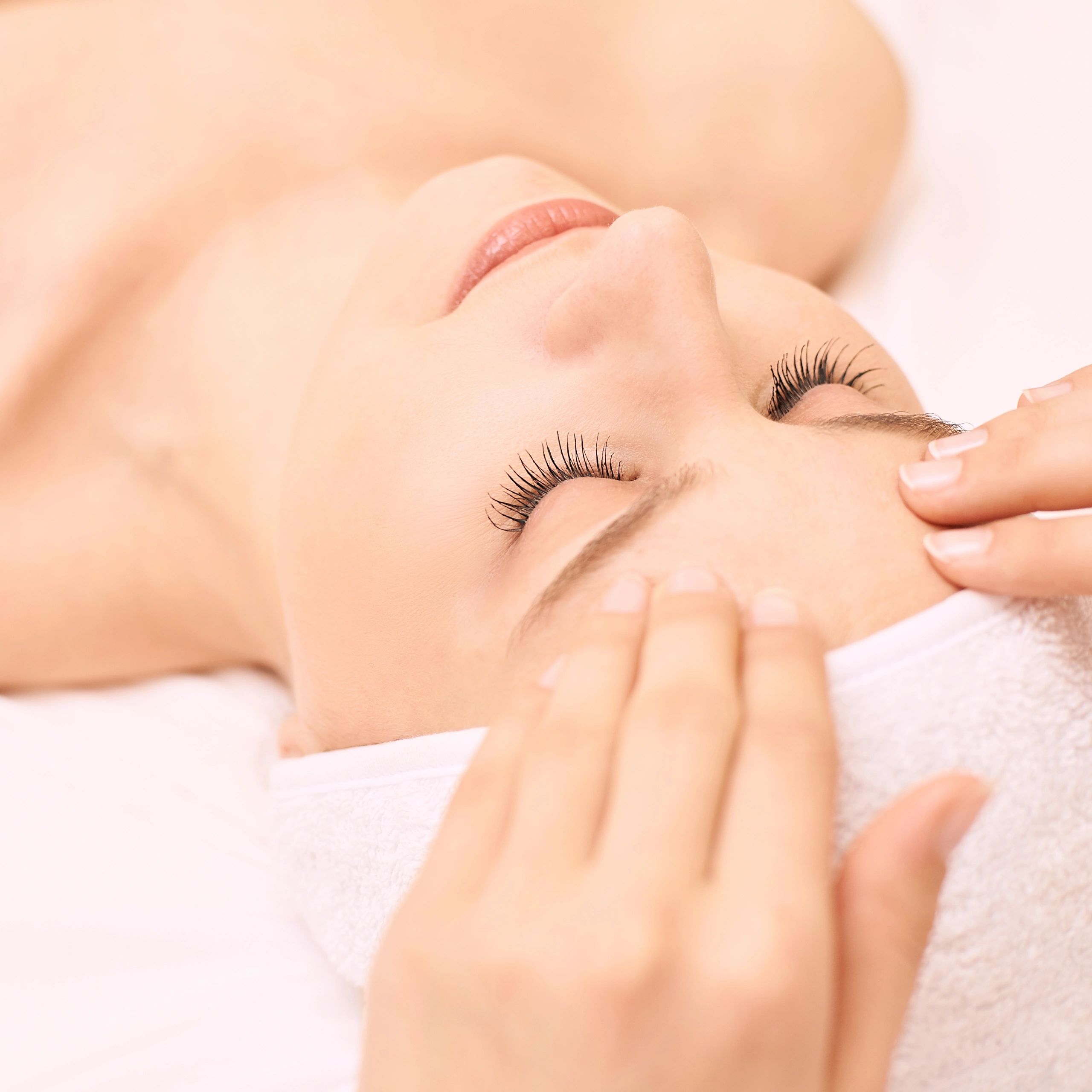 Relaxed spa guest receiving a facial treatment